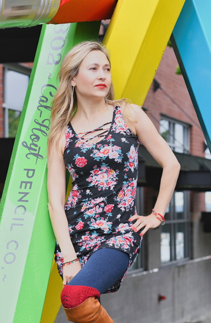 Creative outdoor portrait — woman in floral dress against colorful urban backdrop